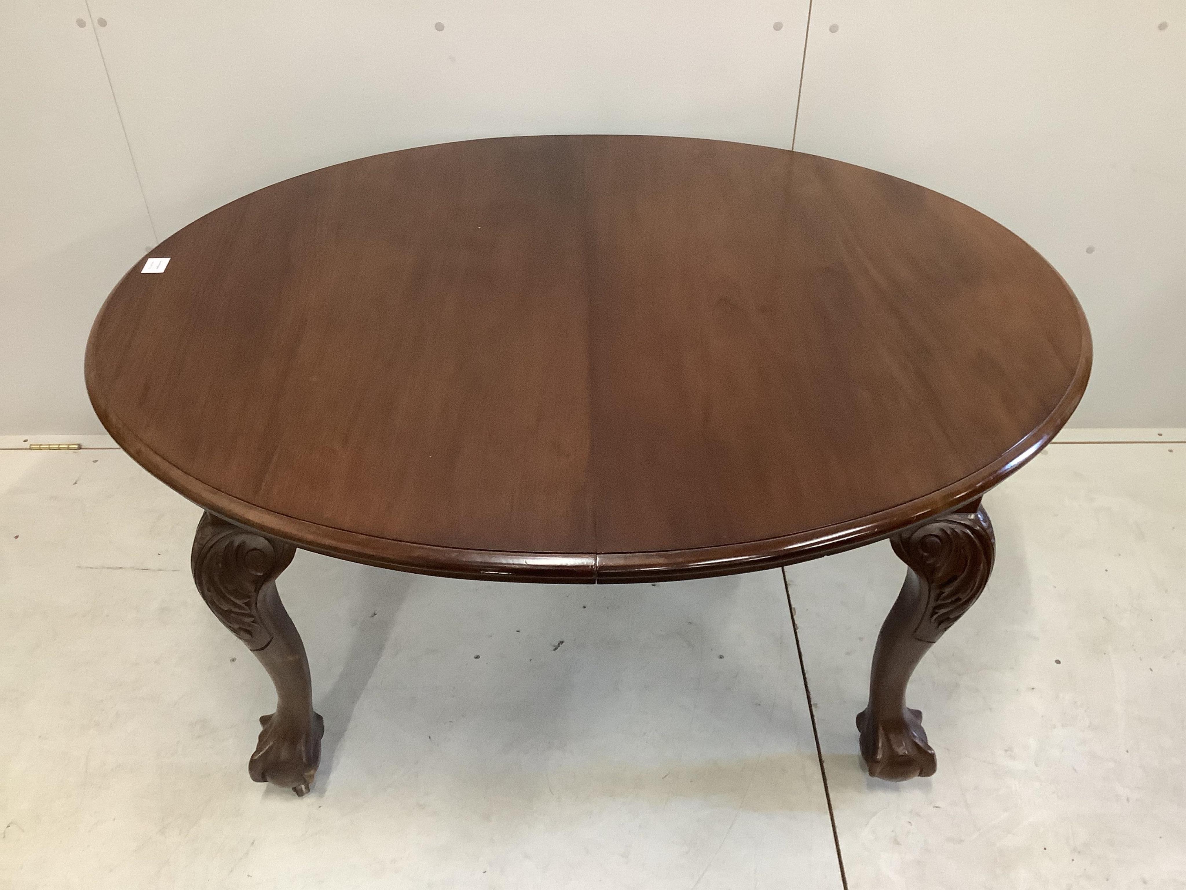 A 1930's walnut extending dining table, 182cm extended, height 106cm and a set of six Queen Anne Revival dining chairs. Condition - fair to good